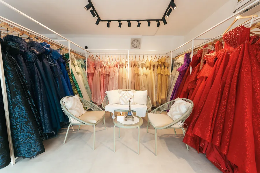 A client trying on a red gown at the studio